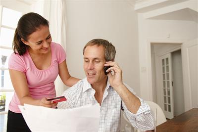 Couple Making Payment Over Phone