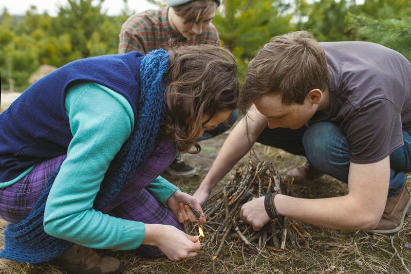 teenagers setting campfire