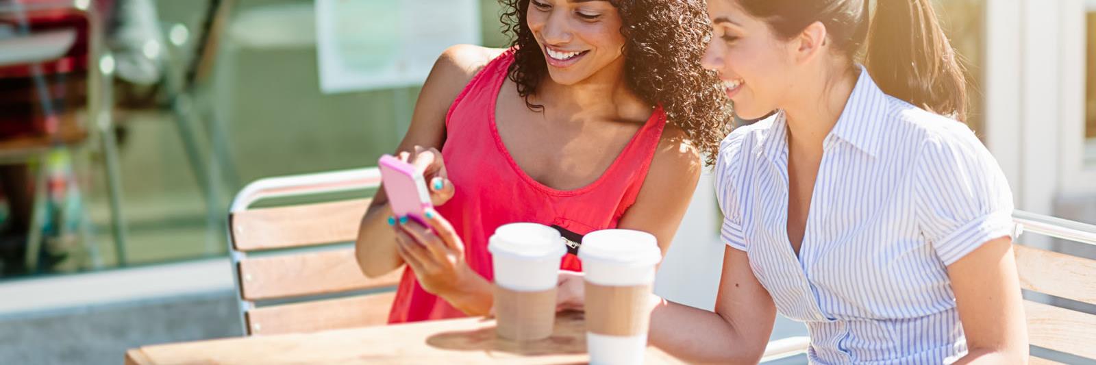 two-women-phone-sidewalk-cafe_web_1600x1067_color