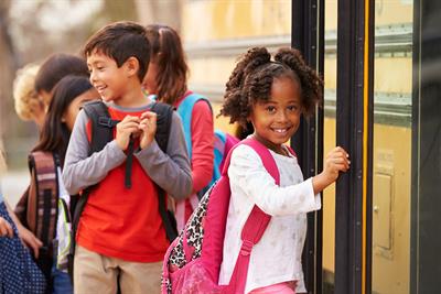 Elementary Kids Line Up Outside of the Bus