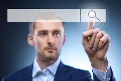 man pressing search button on touch screen