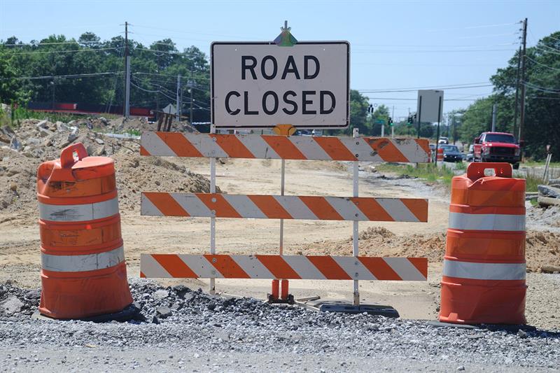 Road closed sign on dirt road