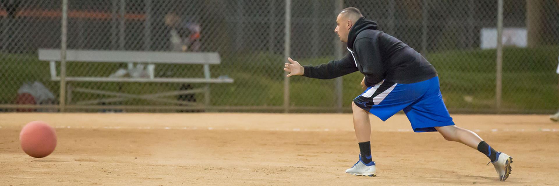 man-pitching-during-kickball-game-1600x533