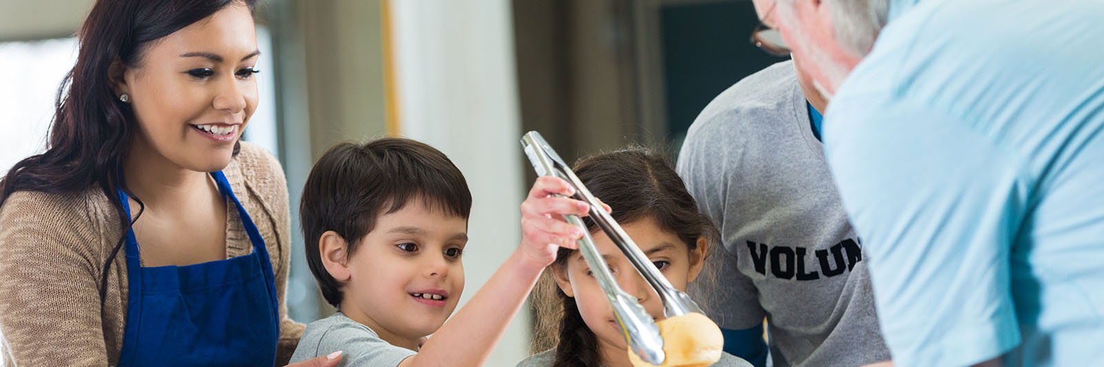 young-hispanic-family-volunteering-to-serve-food-in-soup-kitchen-1600x533