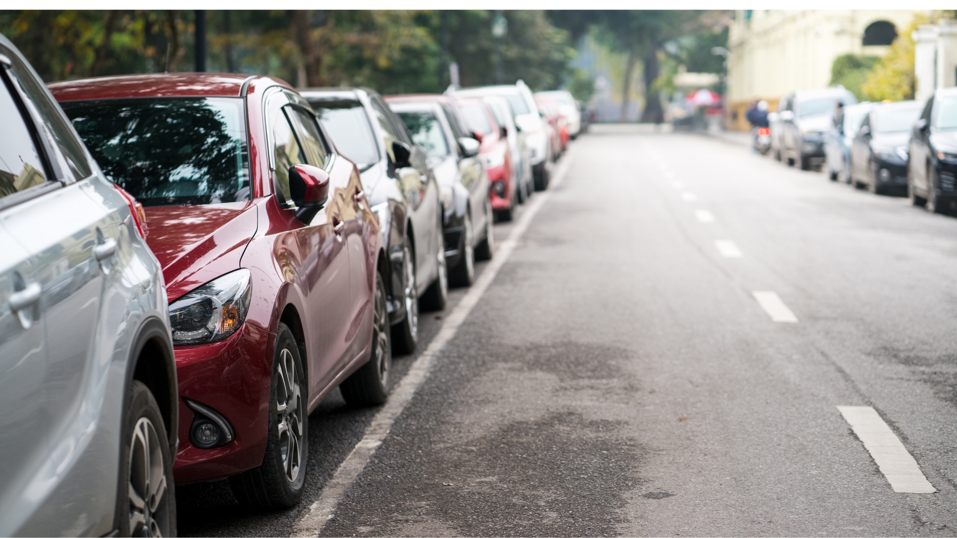 Cars parked by street.