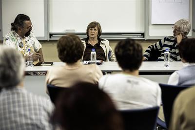 senior woman speaks at group panel