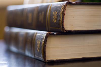 two old leather bound books on table