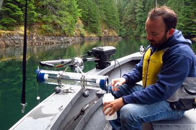 man testing water on a boat