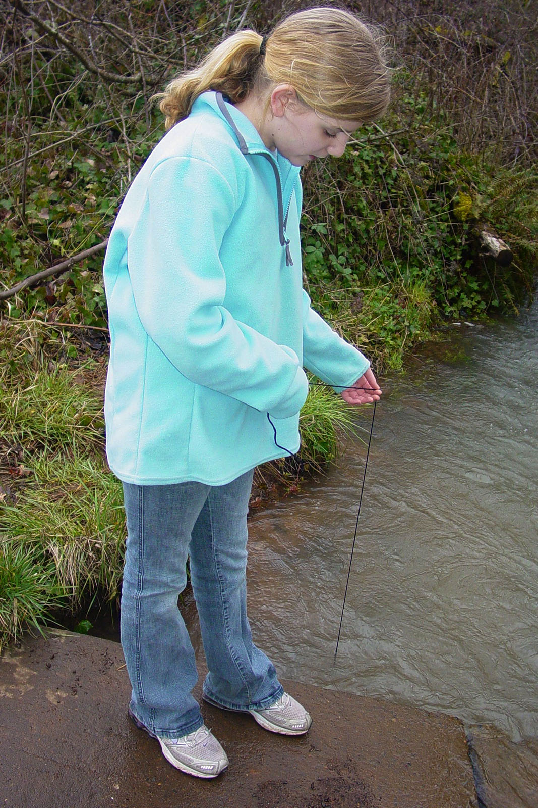 Girl Measuring Stream Depth