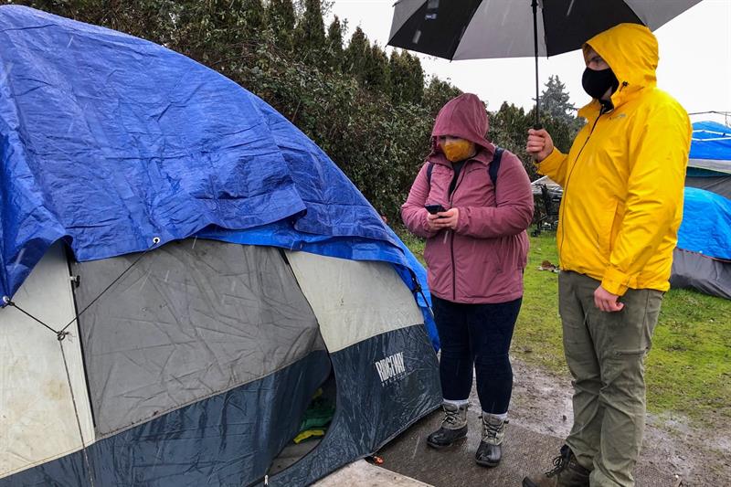 woman and man standing next to tent