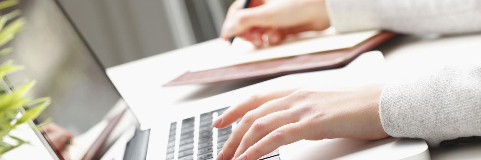 Woman's hand on laptop keyboard